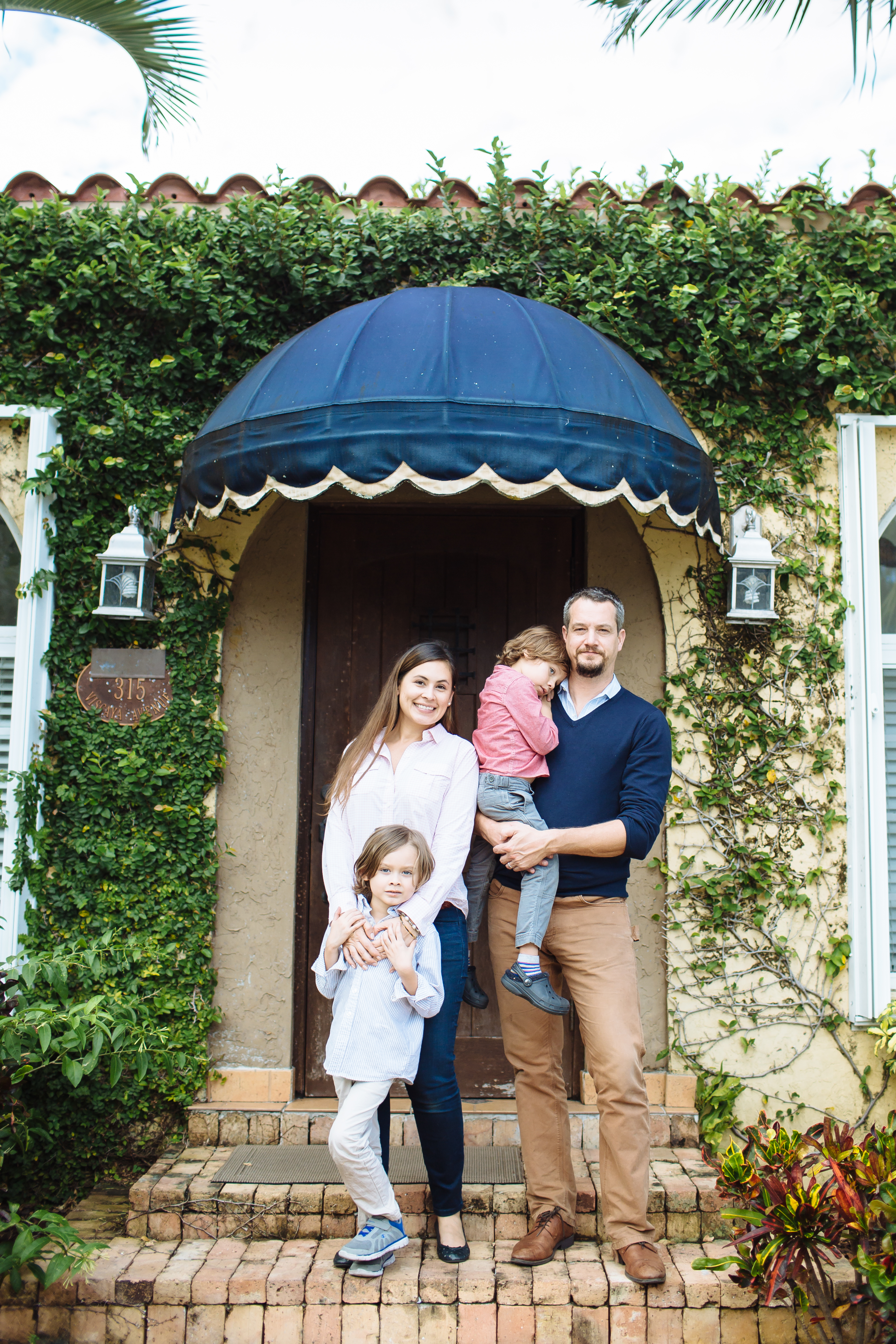 Family stands in front of their newly-upgraded energy-efficient home.