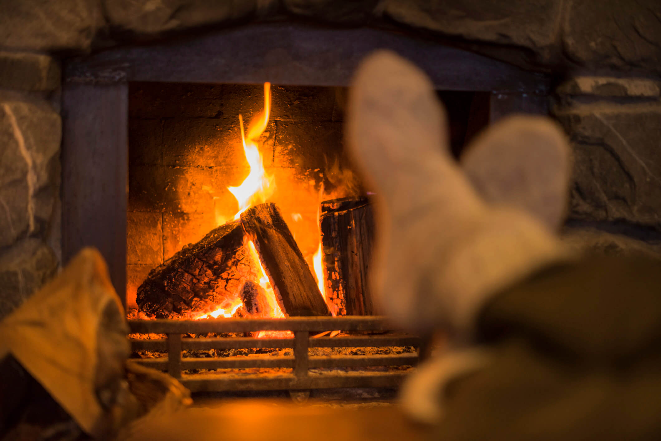 feet by home fireplace