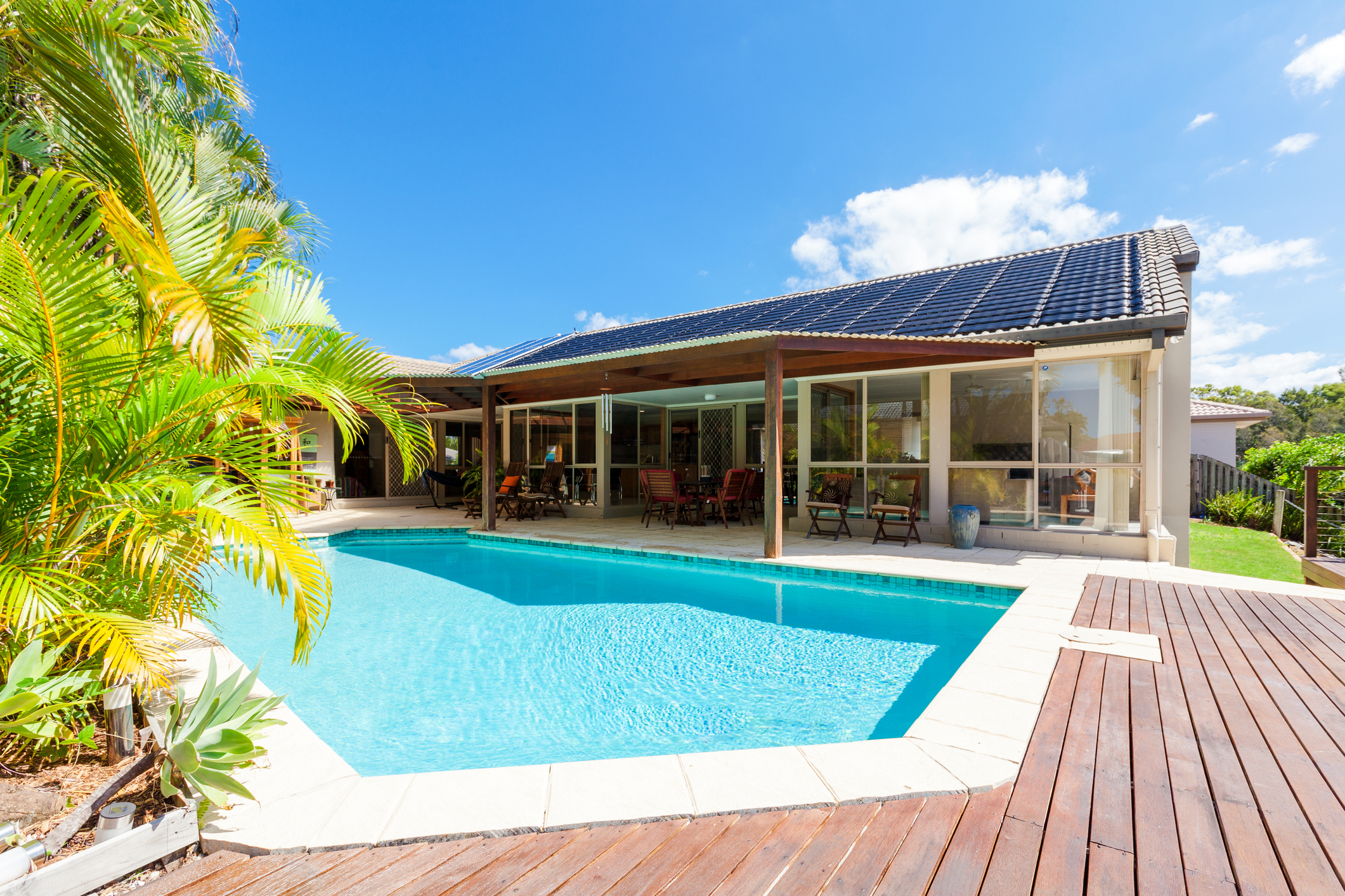 Backyard of home with solar panels and swimming pool