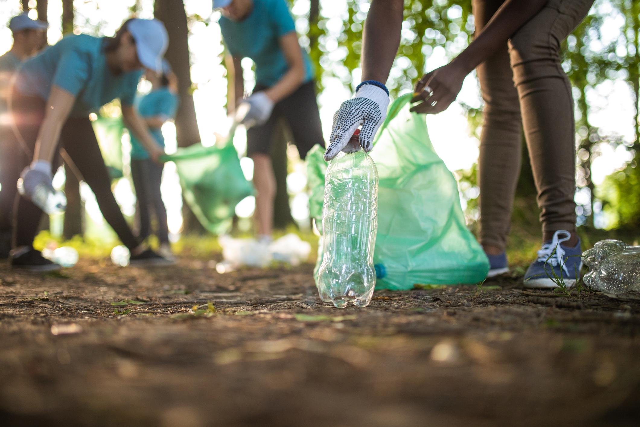 Volunteers picking up bottles to recycle them on Earth Day.