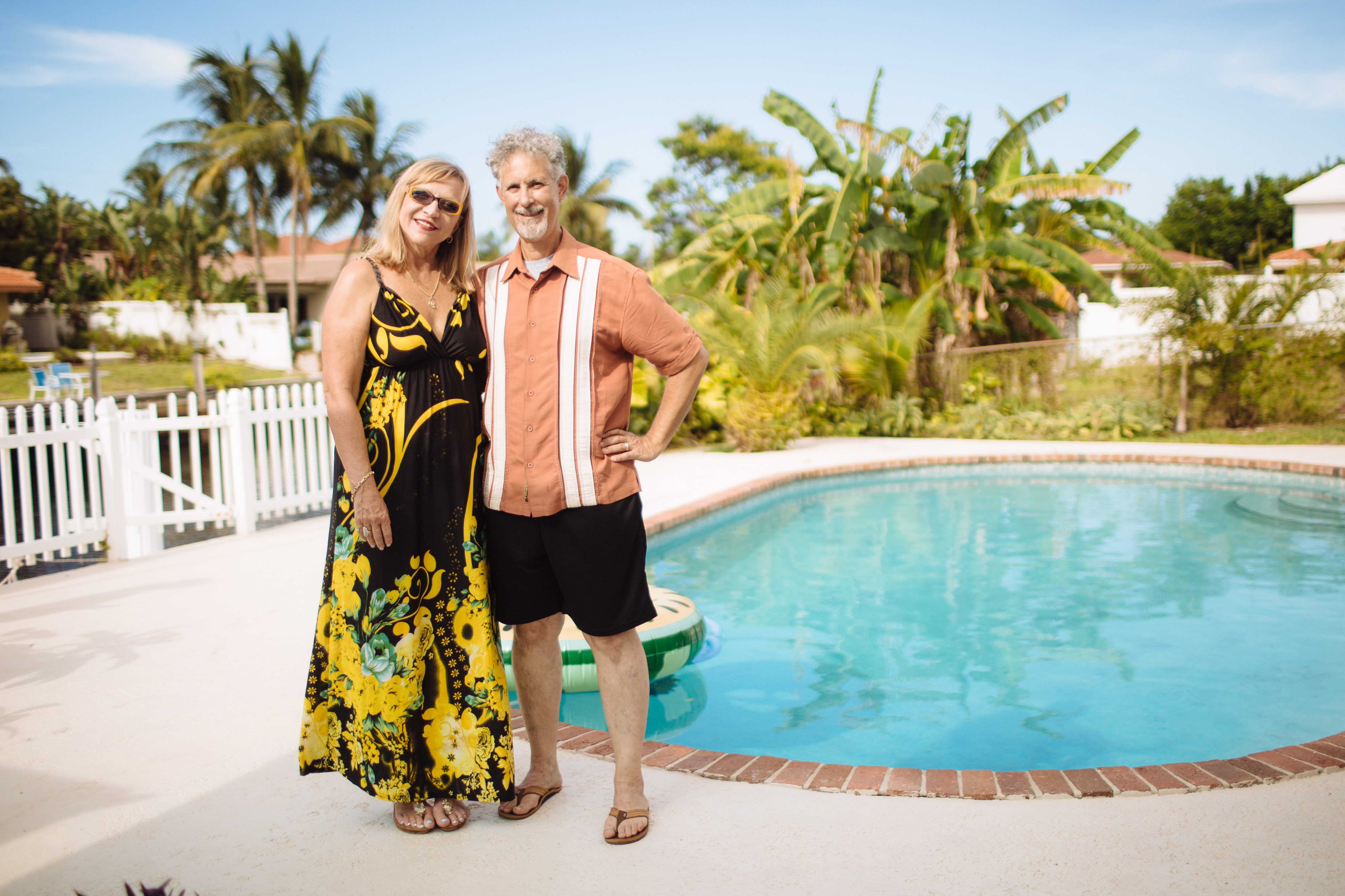 Happy couple in front of their new energy-efficient pool