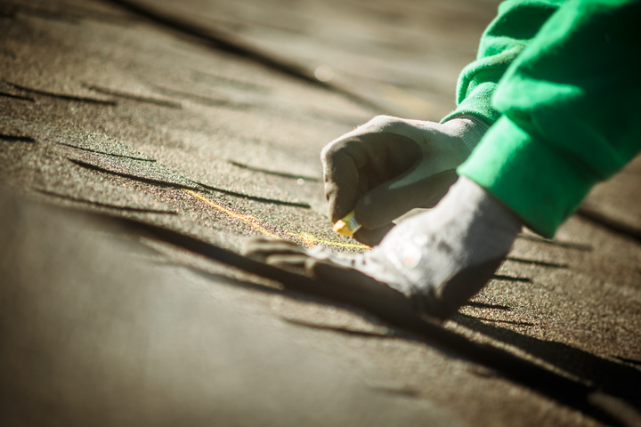 man working on roof tiles